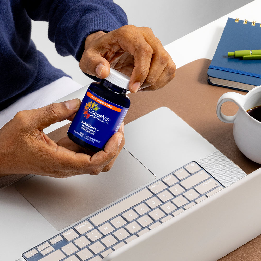 model pouring capsules into hand with laptop