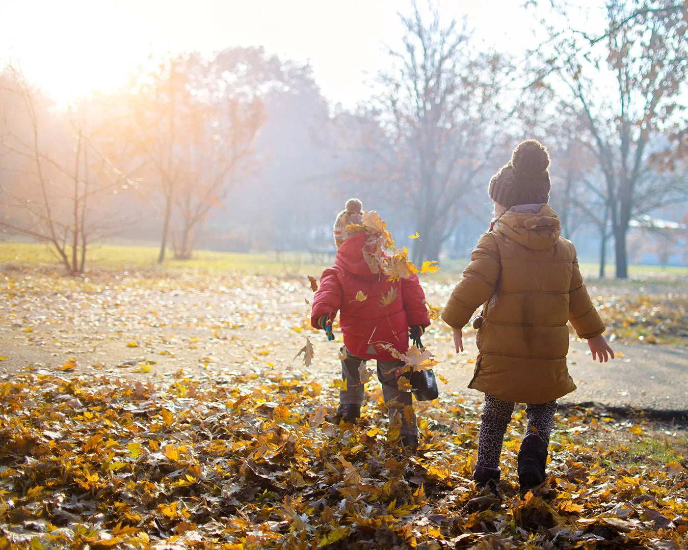 two kids playing with leaves