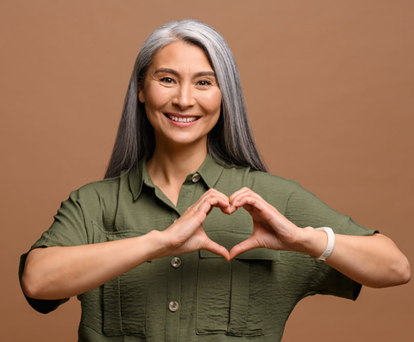 elderly woman holding heart