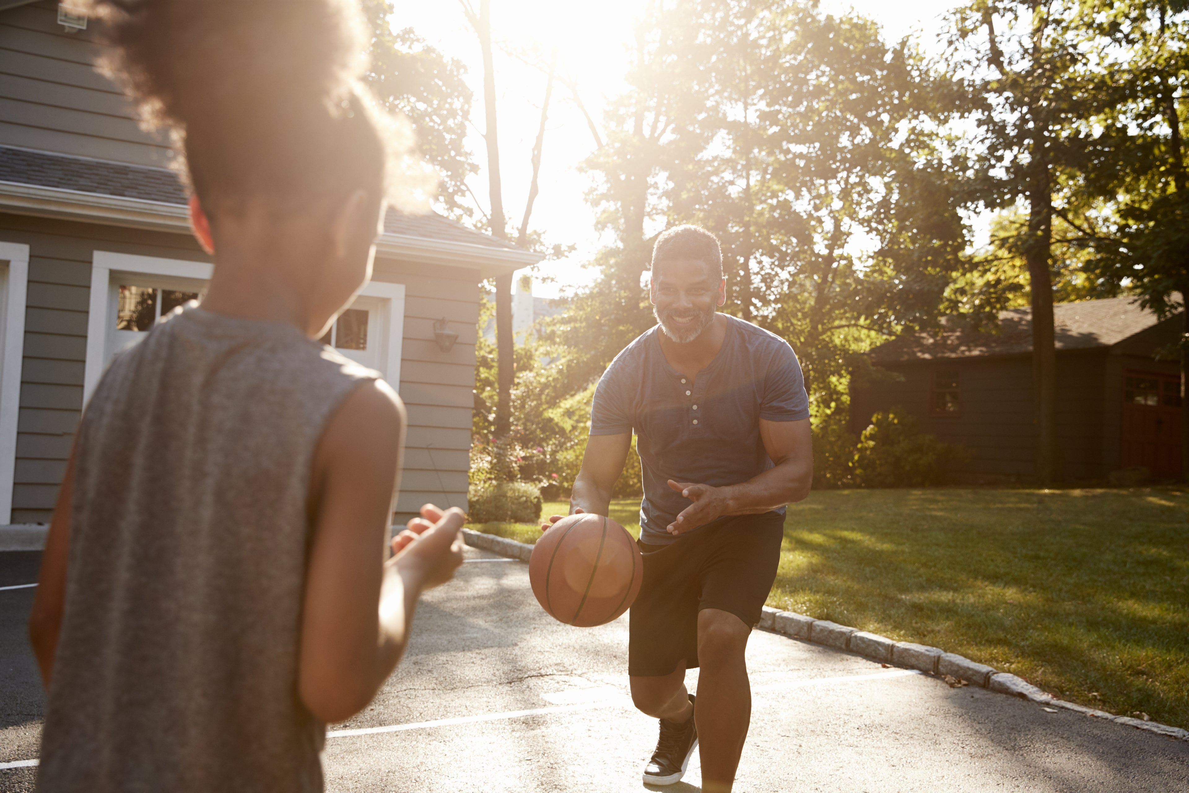 Father and daughter playing basketball