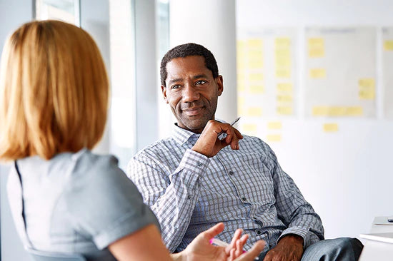 Business man talking to another professional woman