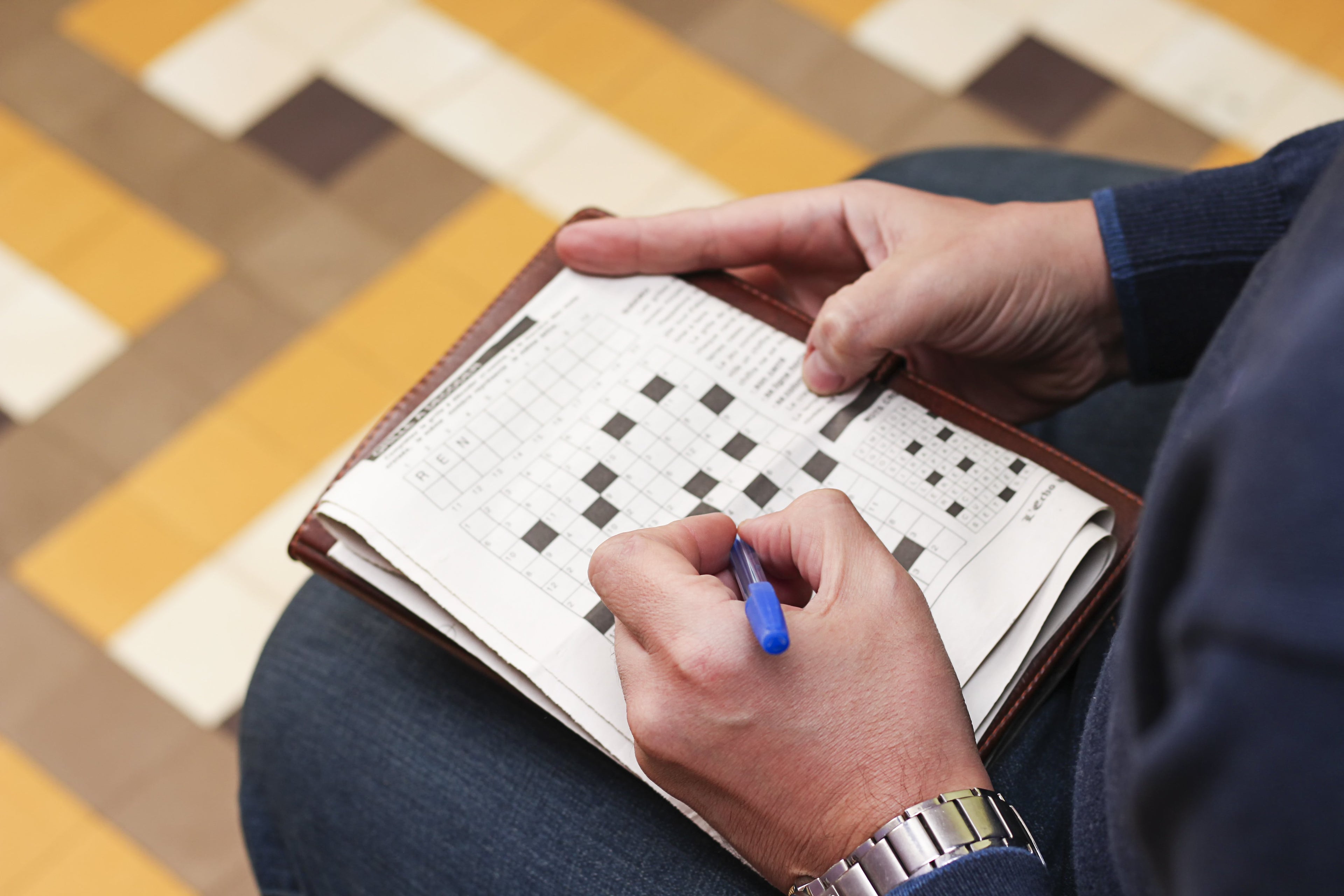 Someone doing a crossword puzzle