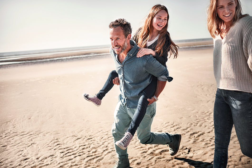 Father and daughter on beach playing