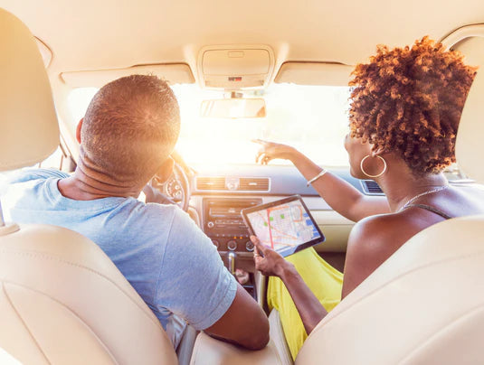 African American Couple navigating in card with maps