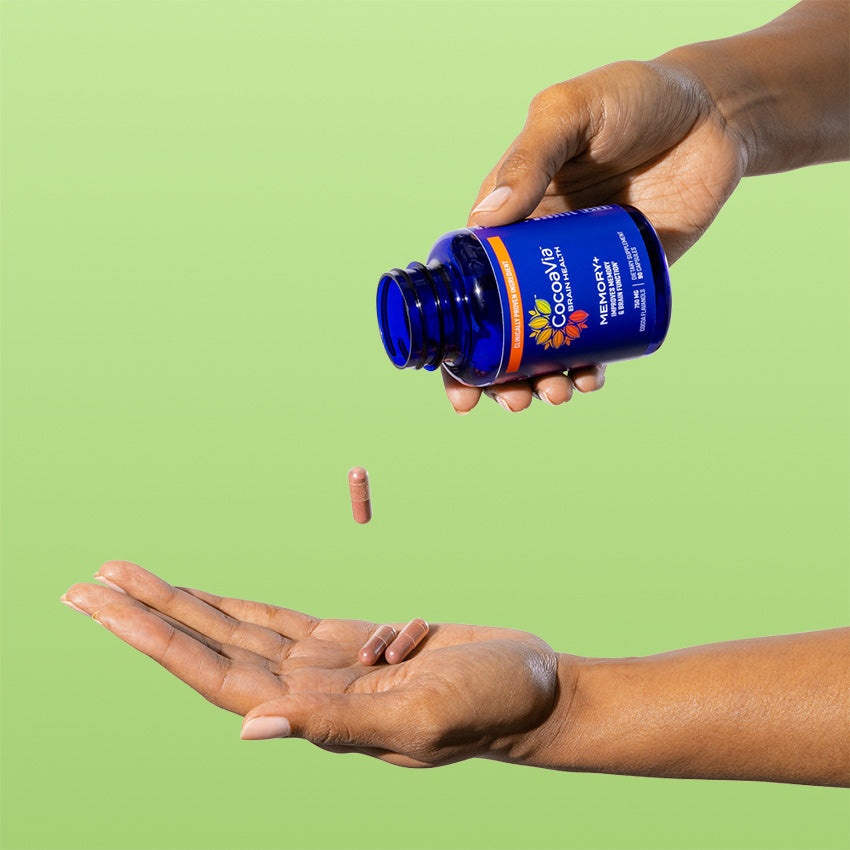 Person pouring CocoaVia Memory+ bottle and  pouring capsule onto hand