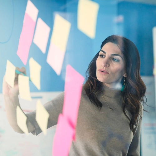 woman with sticky notes on wall