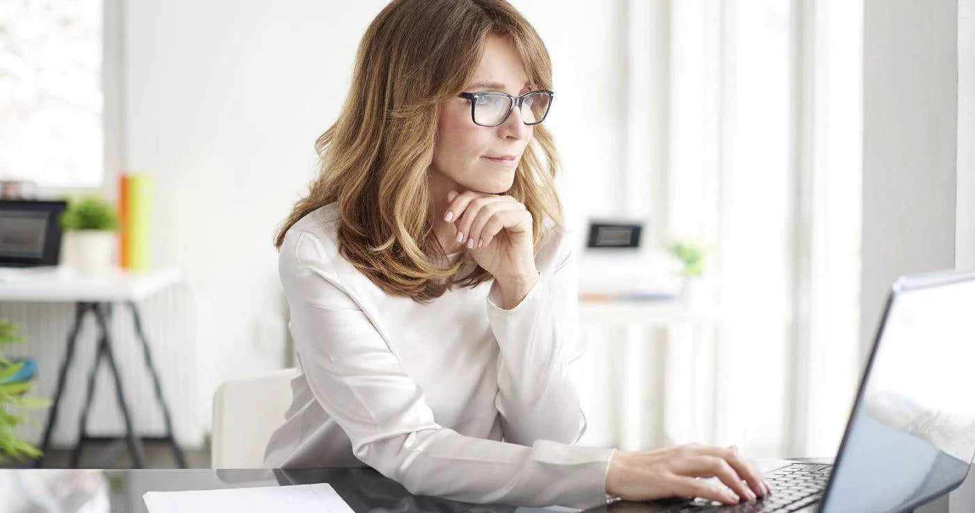 Elderly woman looking at computer